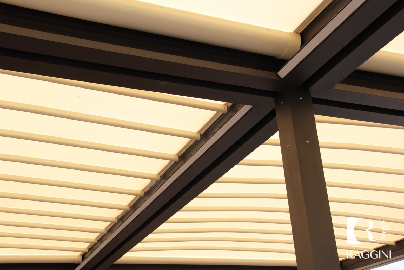 Pergola con copertura in tessuto illuminata da strisce LED integrate nella struttura, vista dal basso