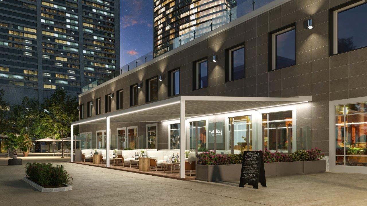 Pergola Illumia illuminata davanti a un locale in città, di sera